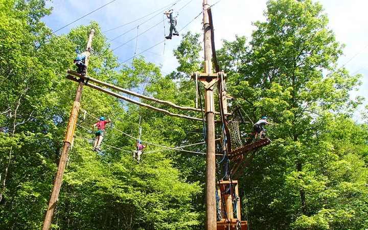 a group of veterans navigate a ropes course